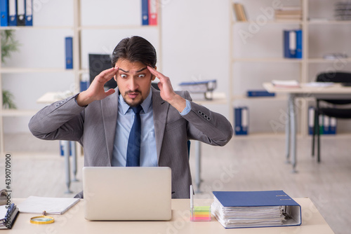 Young male employee working in the office