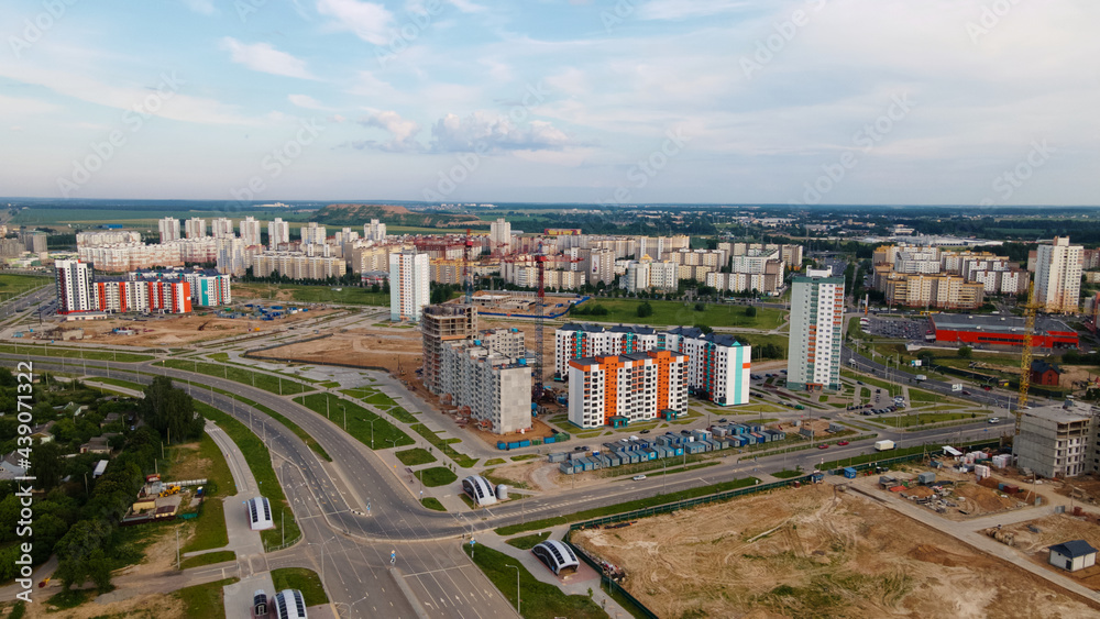 Aerial view of the new urban development. New houses are being built. The cranes are visible.