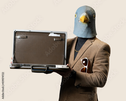 A Business Man Wearing A Pigeon Mask Holds an Open briefcase 