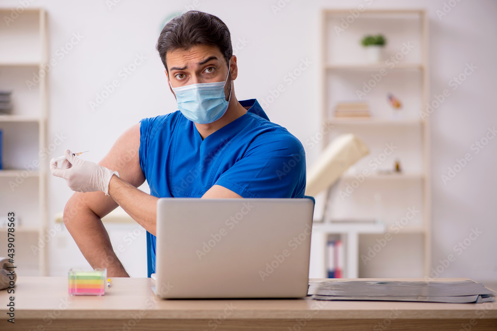 Young male doctor in vaccination concept Young male doctor in vaccination concept