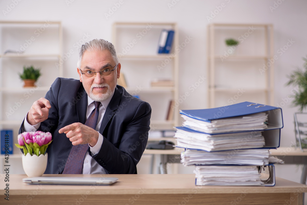 Old businessman florist sitting in the office Old businessman florist sitting in the office