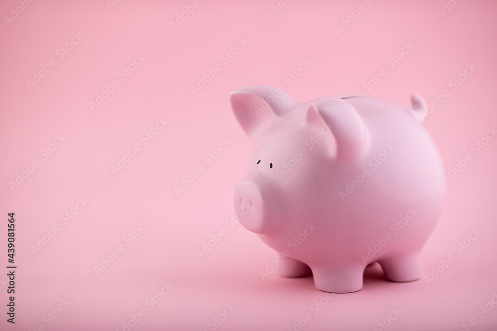 Pink piggy bank on pink background
