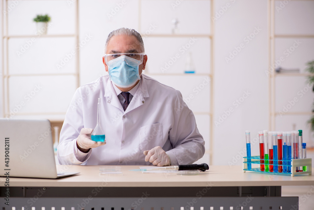 Old male chemist working in the lab during pandemic Old male chemist working in the lab during pandemic