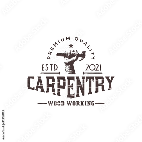 carpentry or wood worker logo with an illustration of hand holding a hammer with a classic style. vector graphic for carpenter logo template.