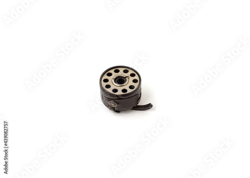 Принти на полотні Sewing machine bobbin and bobbin case isolated on white background