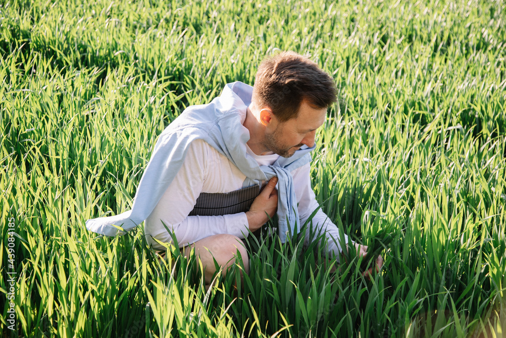 Young farmer with folder under his arm 40 years old checking his forage crop, small bussiness concept photo Young farmer with folder under his arm 40 years old checking his forage crop, small bussiness concept photo