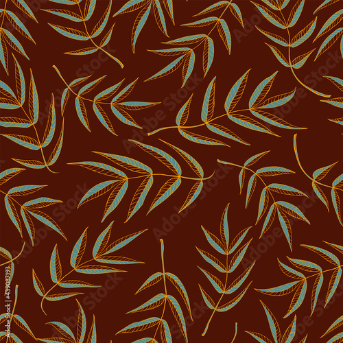 Seamless pattern from leaves of mountain ash in brown and gold tones
