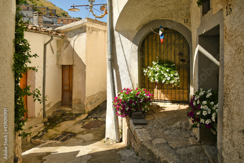 Fototapeta Naklejka Na Ścianę i Meble -  San Fele, Italy, June 12, 2021. A narrow street among the old houses of a medieval village in the Basilicata region.