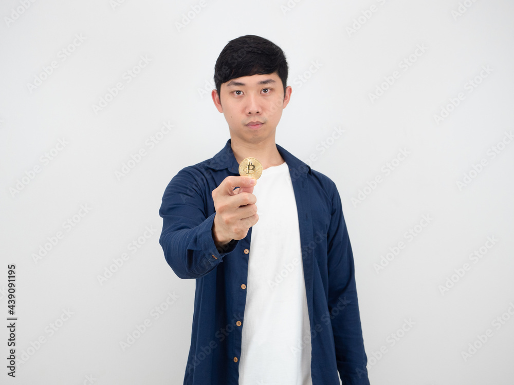 Handsome man show golden bitcoin in his finger with confident face on white background the digital money concept Handsome man show golden bitcoin in his finger with confident face on white background the digital money concept