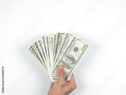 A lot of money bill in hand on white isolated top view