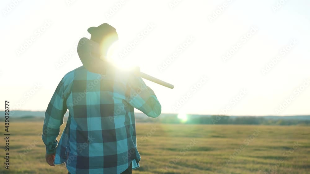 Agriculture. Farmer agronomist in rubber boots walks across field. Agricultural business. Farmer agronomist in field at sunset. Agriculture business concept. Farmer in rubber boots. Farmer businessman Agriculture. Farmer agronomist in rubber boots walks across field. Agricultural business. Farmer agronomist in field at sunset. Agriculture business concept. Farmer in rubber boots. Farmer businessman