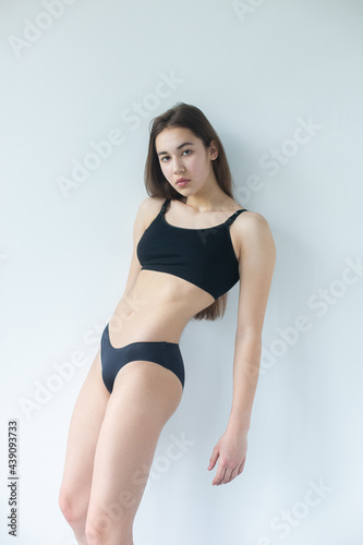 Natural beauty brunette model no make up in swimsuit posing in studio on isolated background. Model tests, natural no make up models concept