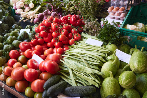 Stand with vegetables on the farmers market - tomatoes  cucumbers and pea pods. Funchal  Madeira  Portugal.