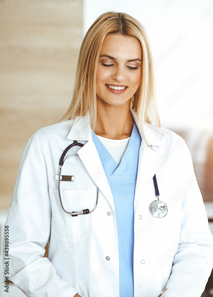 Doctor woman controls medication history records and exam results while using clipboard in sunny hospital . Medicine and healthcare concept Doctor woman controls medication history records and exam results while using clipboard in sunny hospital . Medicine and healthcare concept