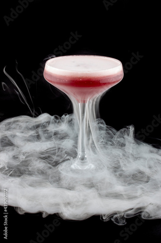 Smoke bubble strawberry cocktail on black background. After bubble burst. Isolated