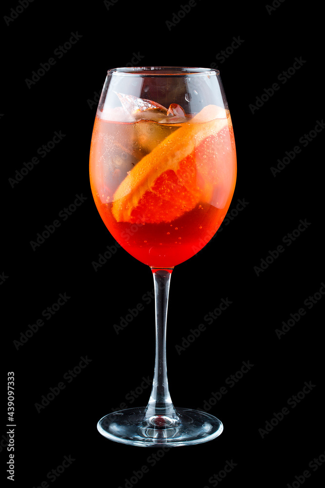 Aperol Spritz cocktail with grapefruit on a dark background. Isolated Aperol Spritz cocktail with grapefruit on a dark background. Isolated