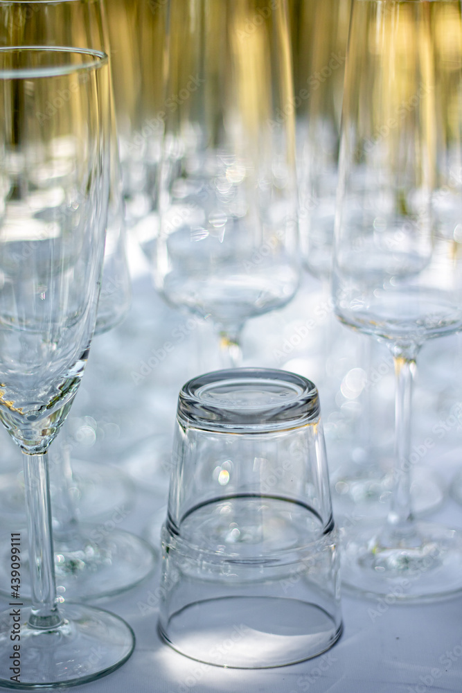 Close up of different glasses, champagne glasses and cocktail glass on a table with white tablecloth, focus on Cocktail glas Close up of different glasses, champagne glasses and cocktail glass on a table with white tablecloth, focus on Cocktail glas