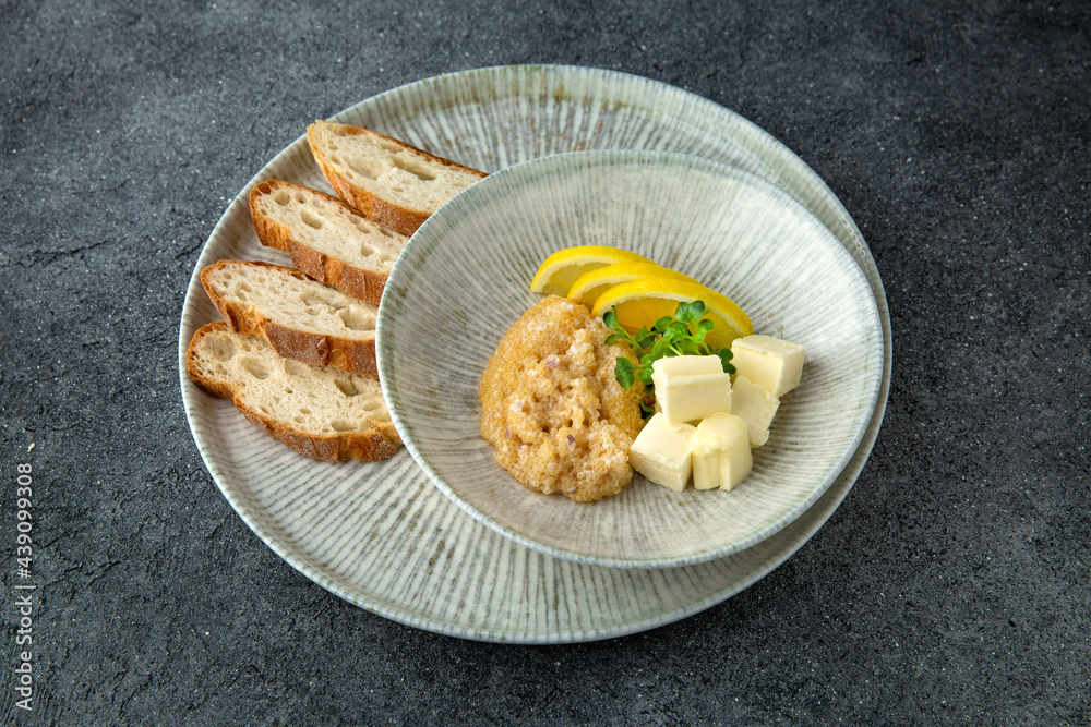 Pike caviar with butter and baguette. Delicious appetizer. Ready menu for the restaurant. Neutral gray blue textured background