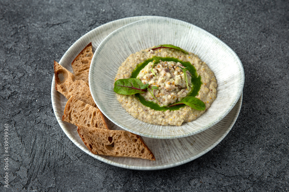 Eggplant, zucchini, mustard seeds and vegetables appetizer. Ready menu for the restaurant. Neutral gray blue textured background Eggplant, zucchini, mustard seeds and vegetables appetizer. Ready menu for the restaurant. Neutral gray blue textured background