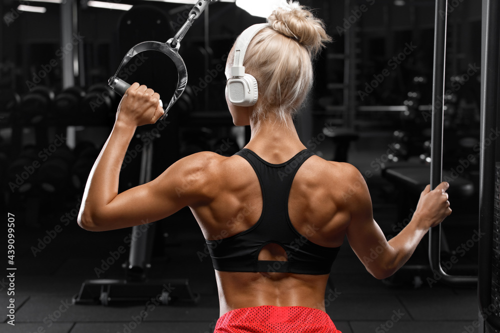 Fitness woman with muscular back in gym. Athletic girl working out Stock  Photo