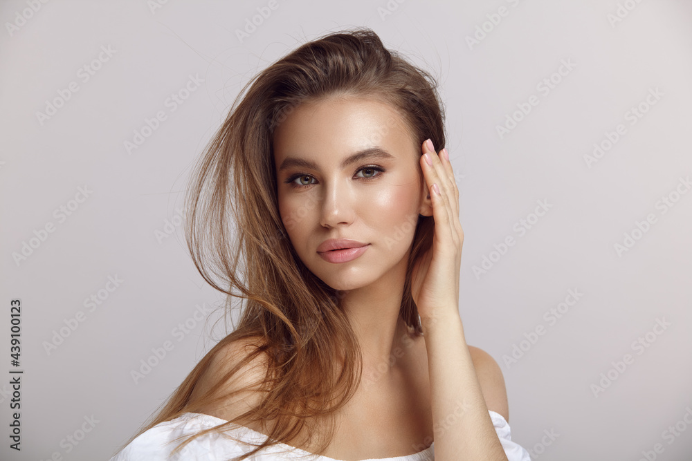 Young woman in stylish dress looks at camera in studio Young woman in stylish dress looks at camera in studio