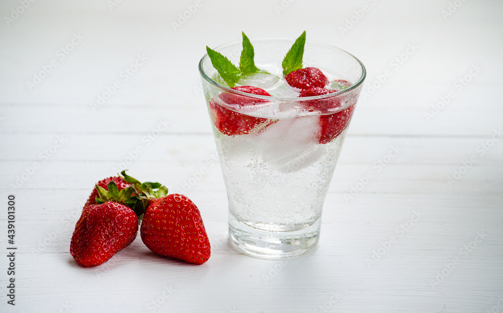 Summer refreshing transparent cocktail with soda, strawberries, mint and ice. Summer refreshing transparent cocktail with soda, strawberries, mint and ice.