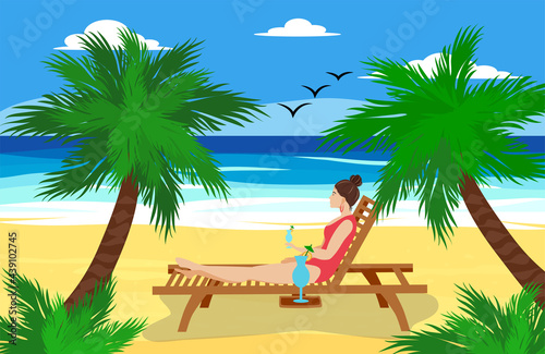 A woman lies on a sun lounger on a sandy beach near the ocean, drinks a cocktail and relaxes. Vacation at sea concept.