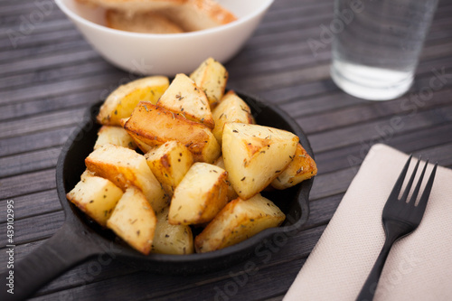 Spanish traditional appetizer patatas bravas on small cast iron skillet