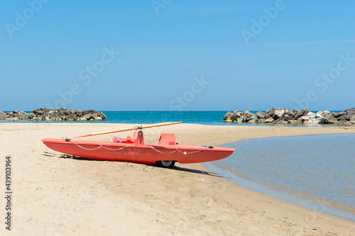 red lifeboat on beach in Italy