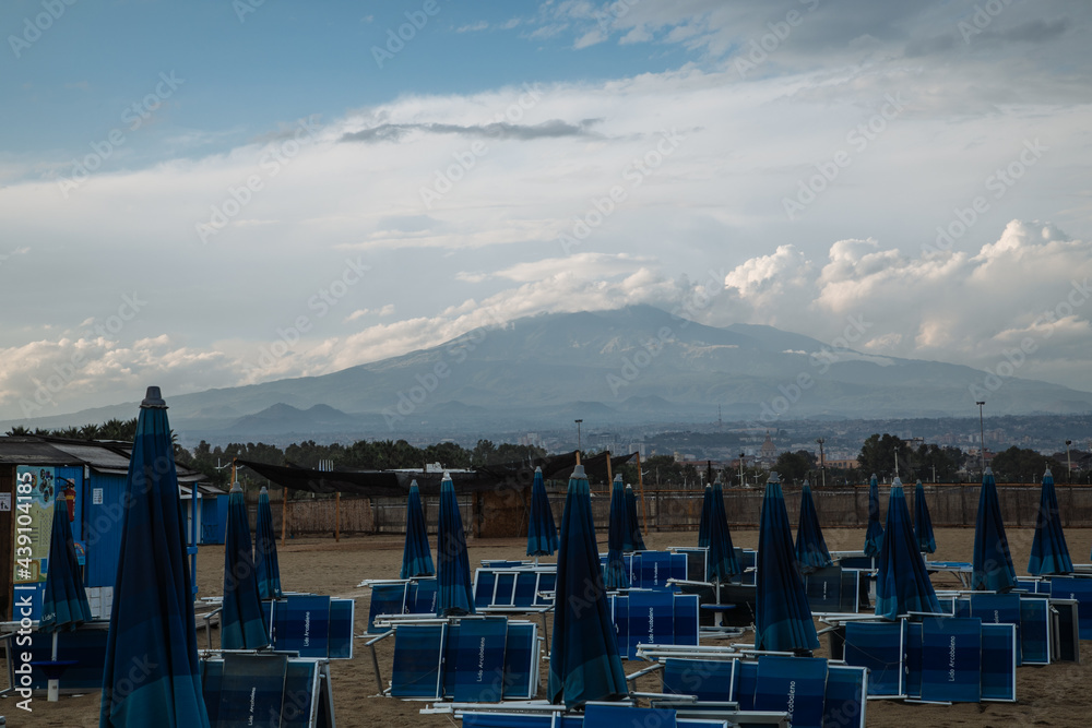 Naklejka premium beach in Catania Sicily with the view of Mount Etna in the distance 