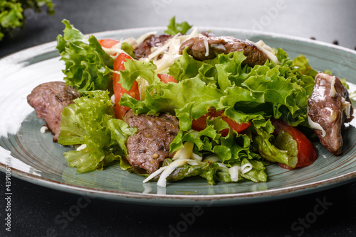 Delicious fresh salad with beef, cheese, tomatoes and lettuce leaves