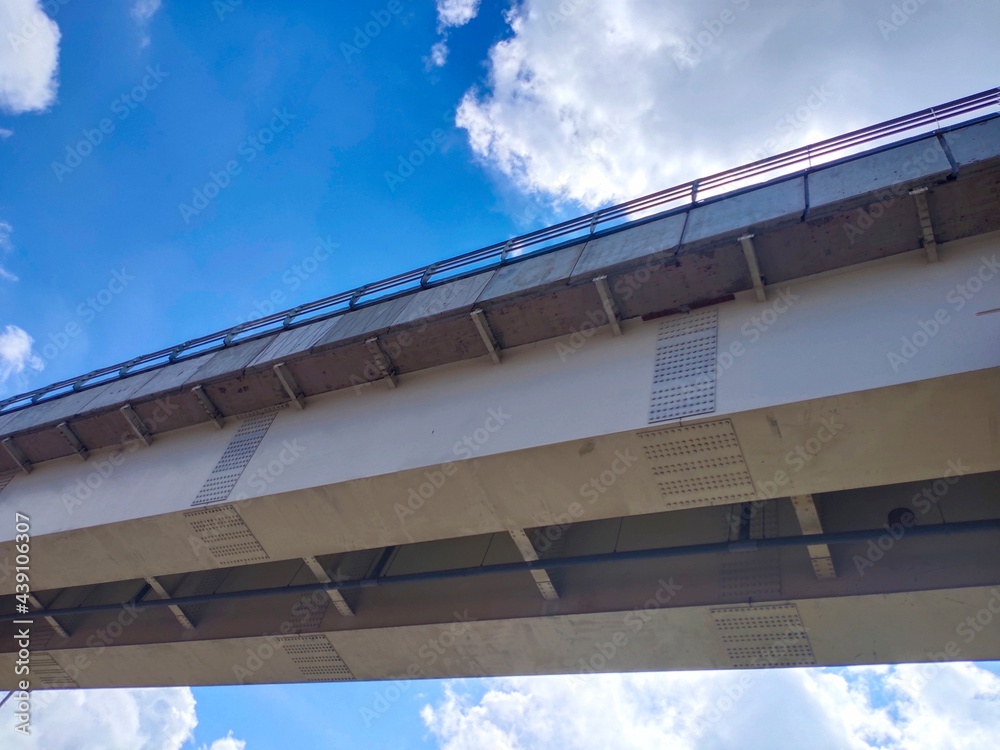 Photo of the LRT train bridge with clouds and sky in the background.