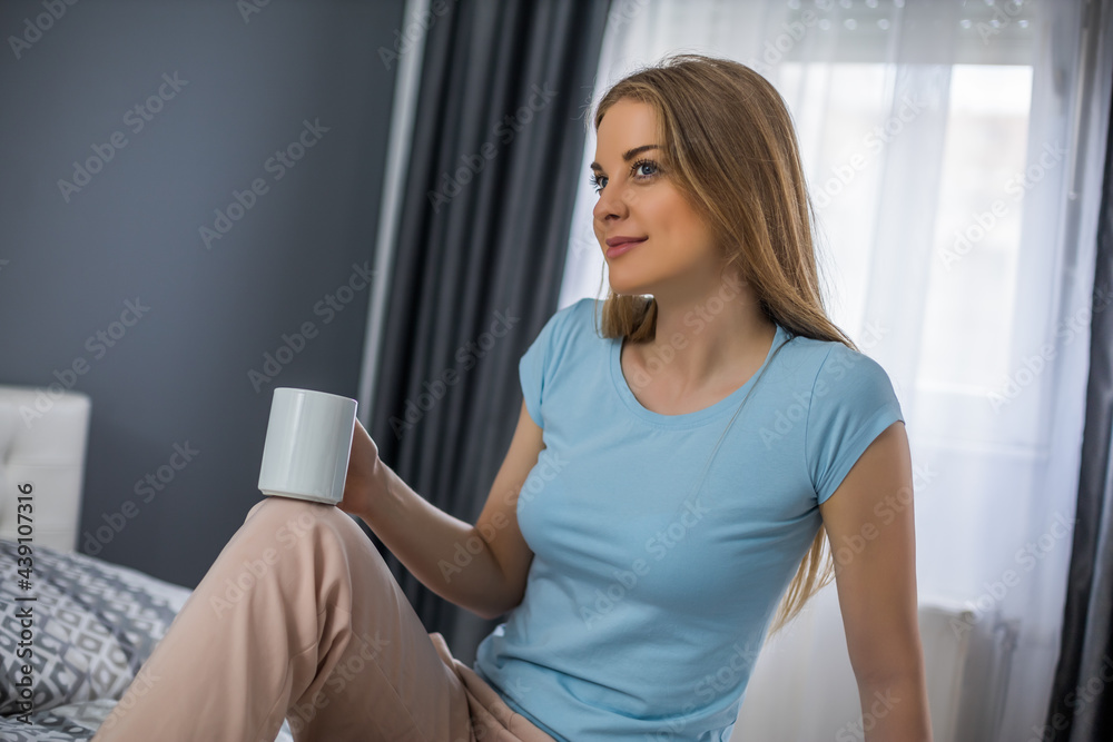 Beautiful woman enjoys drinking coffee in her bed. Beautiful woman enjoys drinking coffee in her bed.