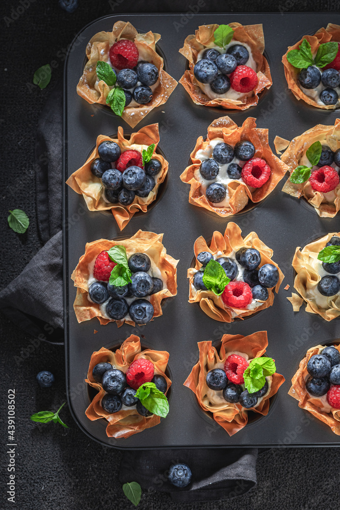 Delicious phyllo cups with blueberries and raspberries. Summer dessert.
