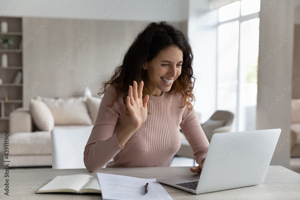 Smiling Hispanic woman work online on computer at home greet wave talk speak on video call on device. Happy Latino female use laptop have webcam video virtual event with client or teacher. Smiling Hispanic woman work online on computer at home greet wave talk speak on video call on device. Happy Latino female use laptop have webcam video virtual event with client or teacher.
