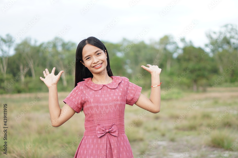 Asian woman smiling happily raise your hand to the sky nature background Asian woman smiling happily raise your hand to the sky nature background