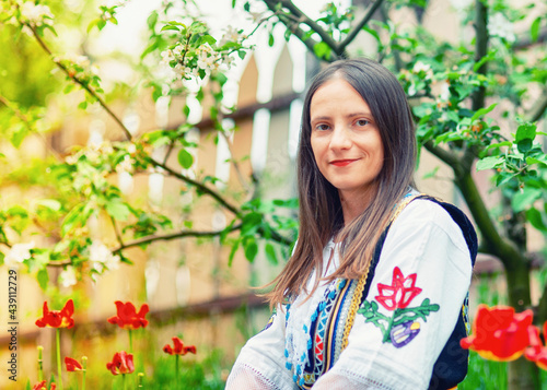 A young woman is posing in a traditional Serbian handmade outfit Litak (narodna nošnja Litak)
