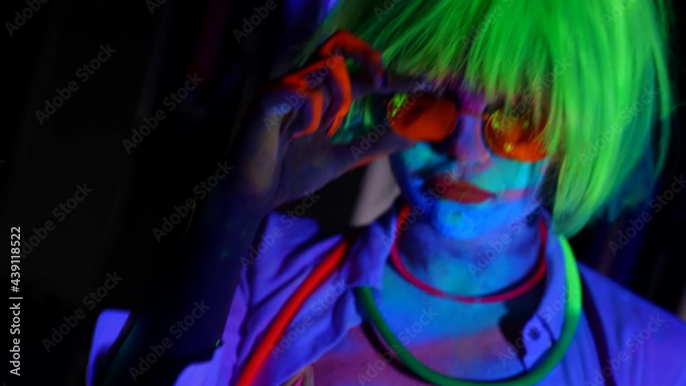 neon and fluorescent makeup and body art on young woman in darkness neon and fluorescent makeup and body art on young woman in darkness