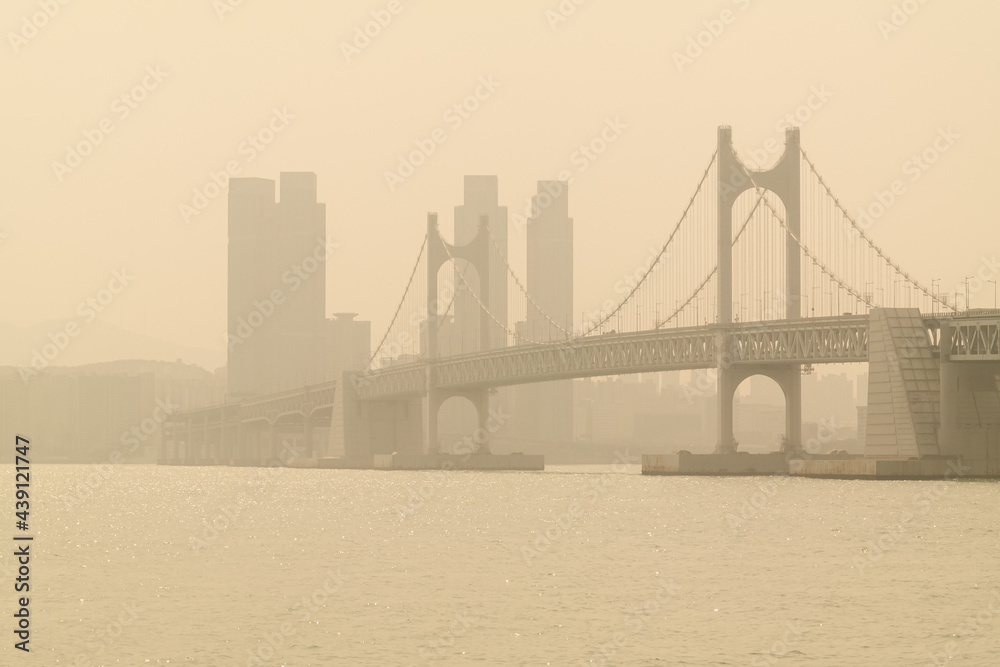 Gwangan Bridge, a landmark in Busan, South Korea, and the city are covered with contaminated yellow dust.