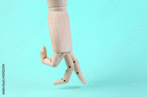 Wooden hand steps with fingers on a blue background