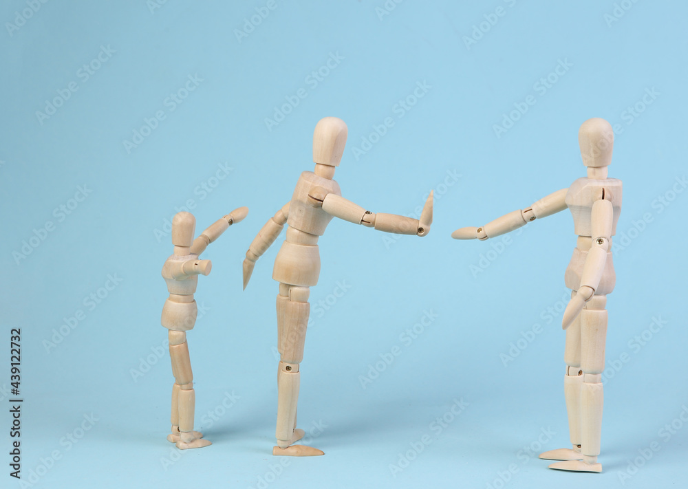 Deprivation of parental rights. Divorce. Family problems concept. The prohibition is seen with the child. Wooden puppets on a blue background Deprivation of parental rights. Divorce. Family problems concept. The prohibition is seen with the child. Wooden puppets on a blue background
