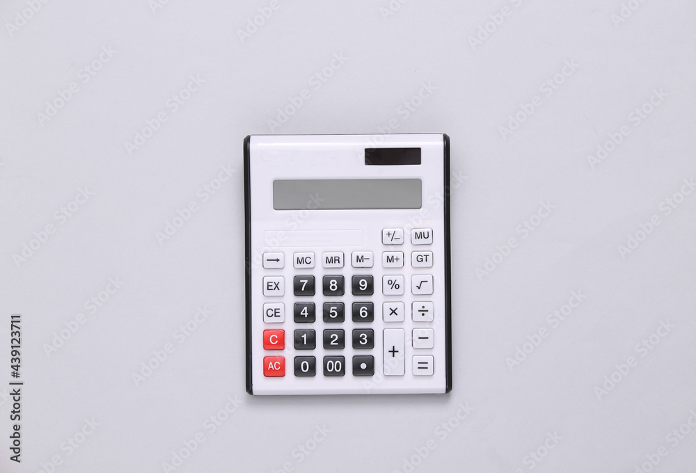 Large white calculator on a gray background. Top view Large white calculator on a gray background. Top view