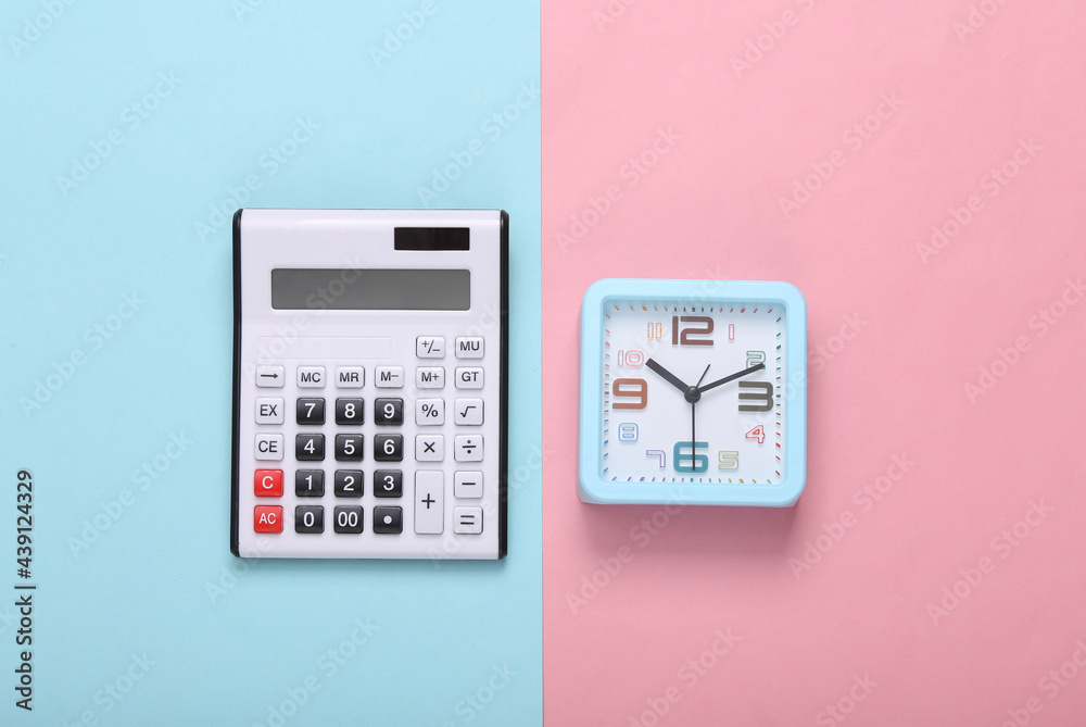 Calculator and clock on a pink blue background. Top view Calculator and clock on a pink blue background. Top view