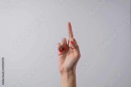 Hand pointing up middle finger, concept of rude hand sign or hand gesture, isolated