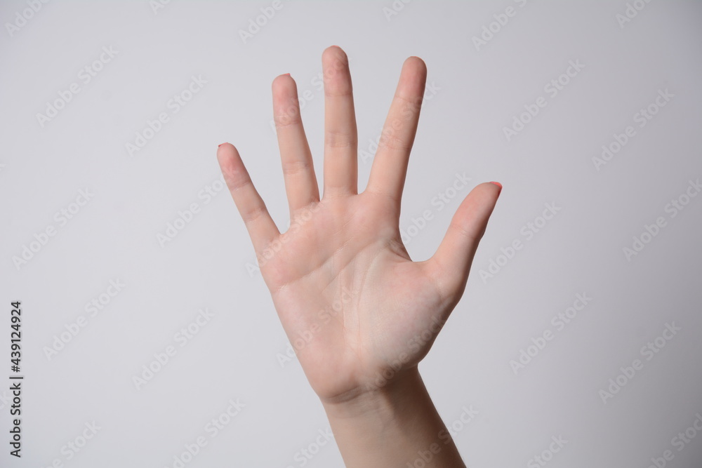 Female hand extended in greeting isolated on white. Number five. Female hand extended in greeting isolated on white. Number five.