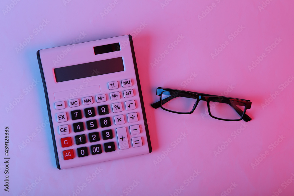 Calculator with glasses in pink blue gradient neon light Calculator with glasses in pink blue gradient neon light