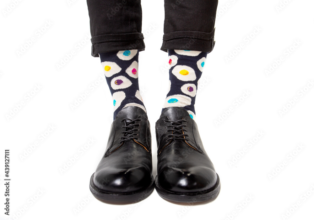Men's feet in stylish shoes and funny socks
