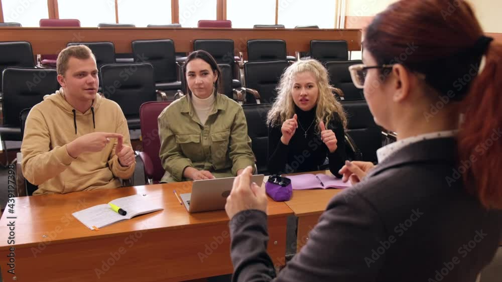 The teacher and students communicate in sign language in the classroom. Hearing impaired and deaf people
