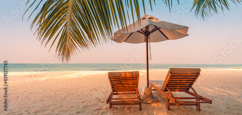 Panoramic beach. Chairs on the sandy beach near the sea. Summer holiday and vacation for luxury tourism. Inspirational tropical landscape. Tranquil scenery, relaxing beach, tropical landscape design