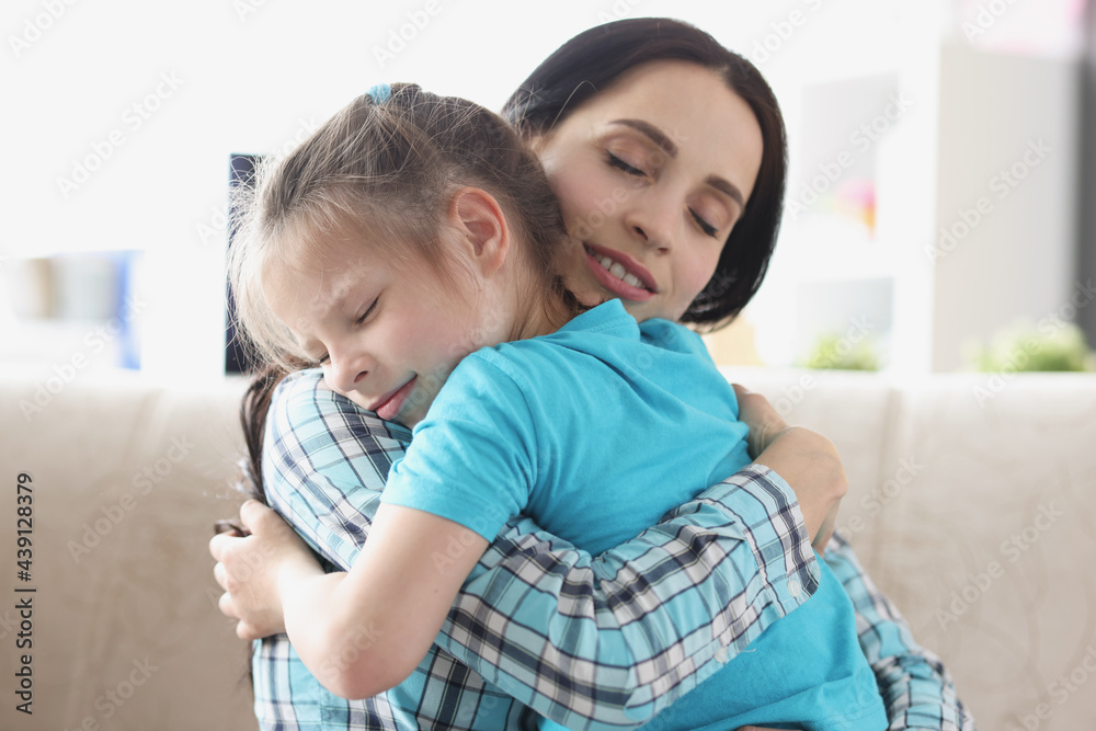 Little girl hugs together with her mother in gentle embrace Little girl hugs together with her mother in gentle embrace